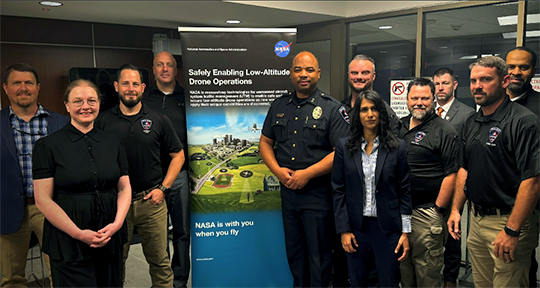 Image of NASA researchers, FAA officials, Department of Homeland Security officials, local police and fire department members and officlas from the Texas Department of Public Safety