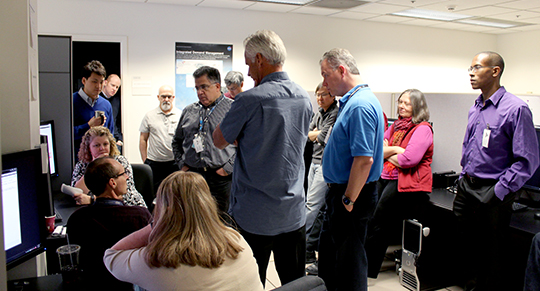 Traffic Flow Management System (TFMS) Deployment Team and representatives from MITRE Corp and MIT Lincoln Labs participate in IDM demonstration in the AOL.