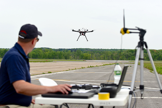 A New York test site pilot launches his drone on another planned maneuver.