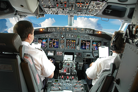 Commercial pilots in the cockpit of a passenger jet