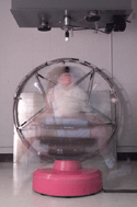 Click to view an image of a research subject being spun in a motion sickness chair during a NASA Psychophysiology Lab research study